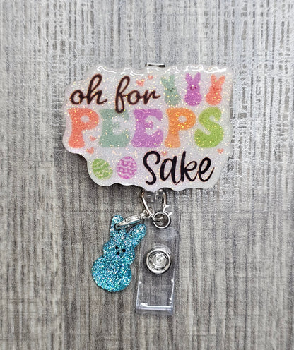 An Easter-themed badge reel with "Oh For Peeps Sake" text and a blue glittery bunny clip attachment.