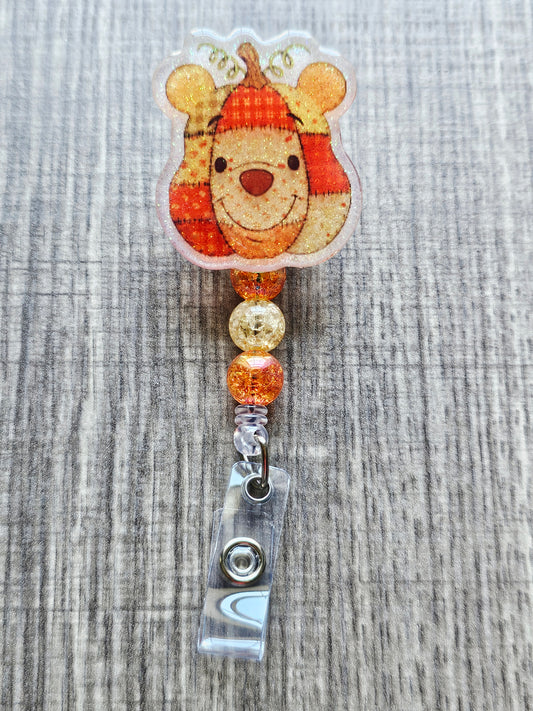 Fall-themed Winnie the Pooh badge reel in a patchwork style with coordinating beads.