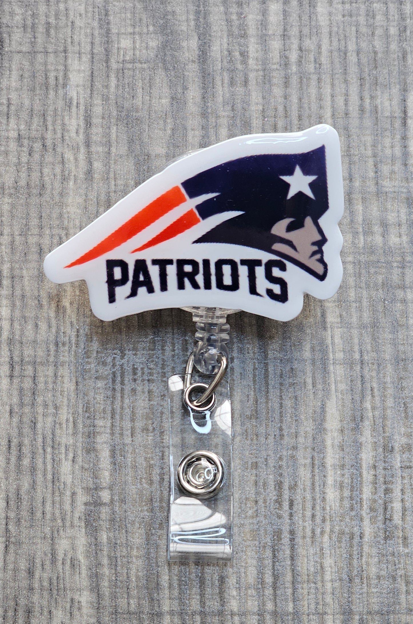 New England Patriots iconic logo and "Patriots" team name on a circular retractable badge reel.