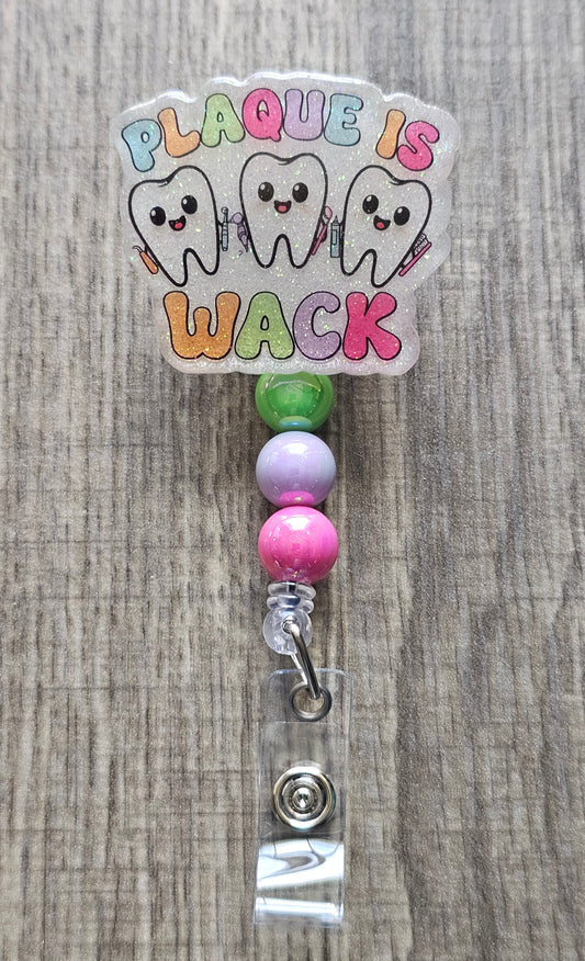 Funny dental badge reel with three happy teeth and Plaque is Wack text.