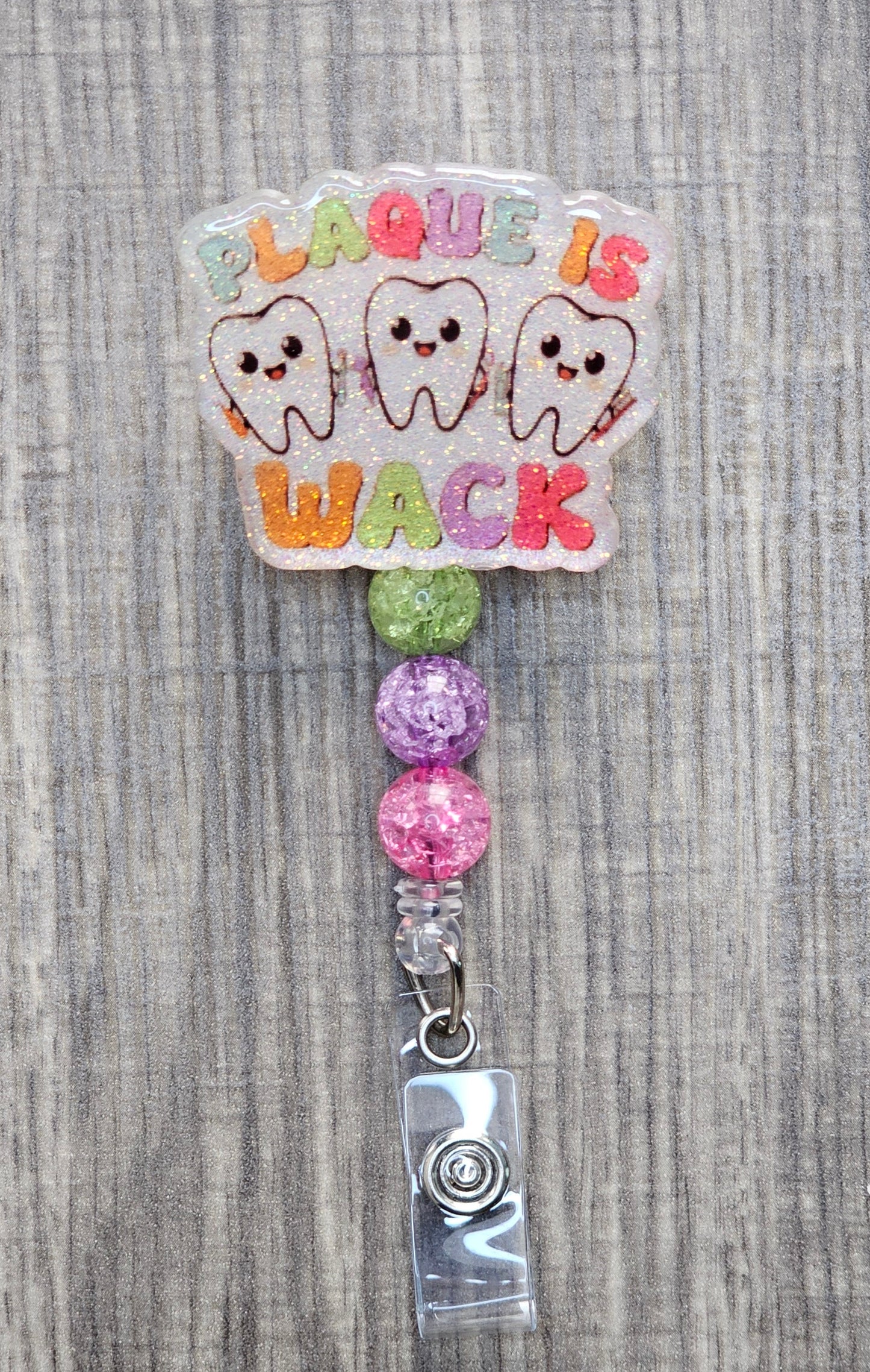 Funny dental badge reel with three happy teeth and Plaque is Wack text.
