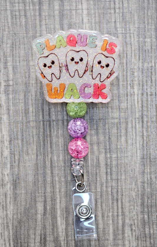 Funny dental badge reel with three happy teeth and Plaque is Wack text.