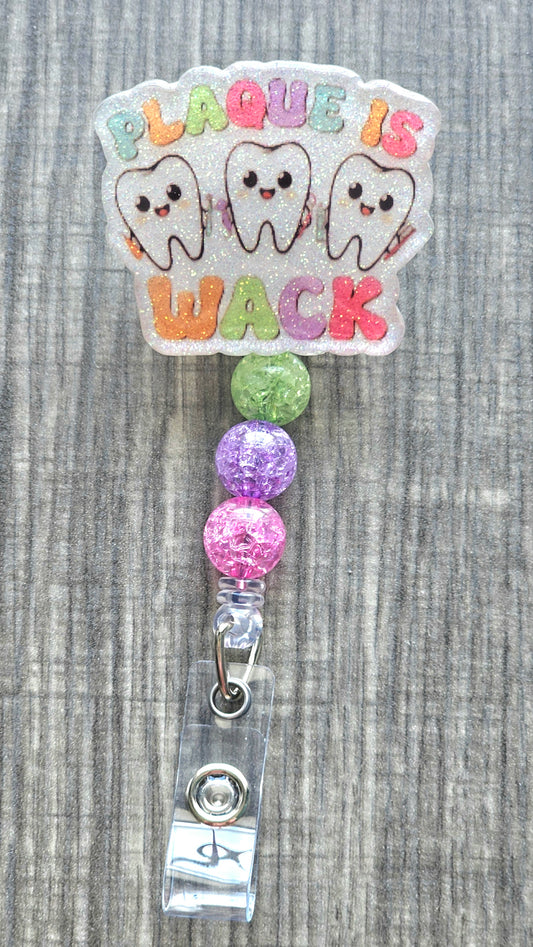 Funny dental badge reel with three happy teeth and Plaque is Wack text.