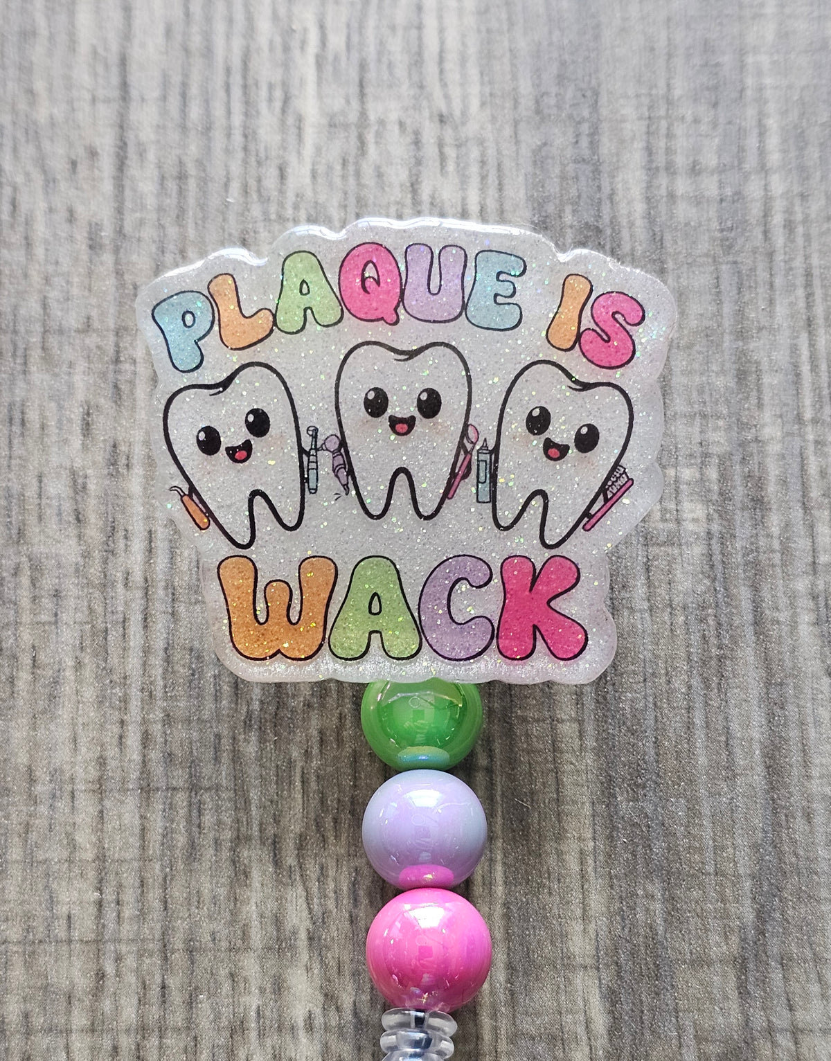 Decorative badge with cartoon teeth and colorful text on a textured background