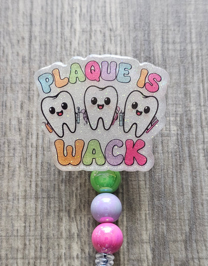 Decorative badge with cartoon teeth and colorful text on a textured background