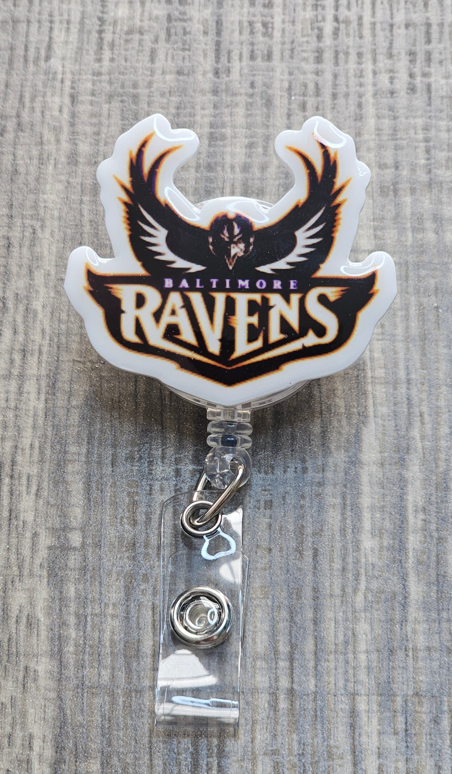 NFL Baltimore Ravens helmet with team logo and "Baltimore Ravens" text on a retractable badge reel.