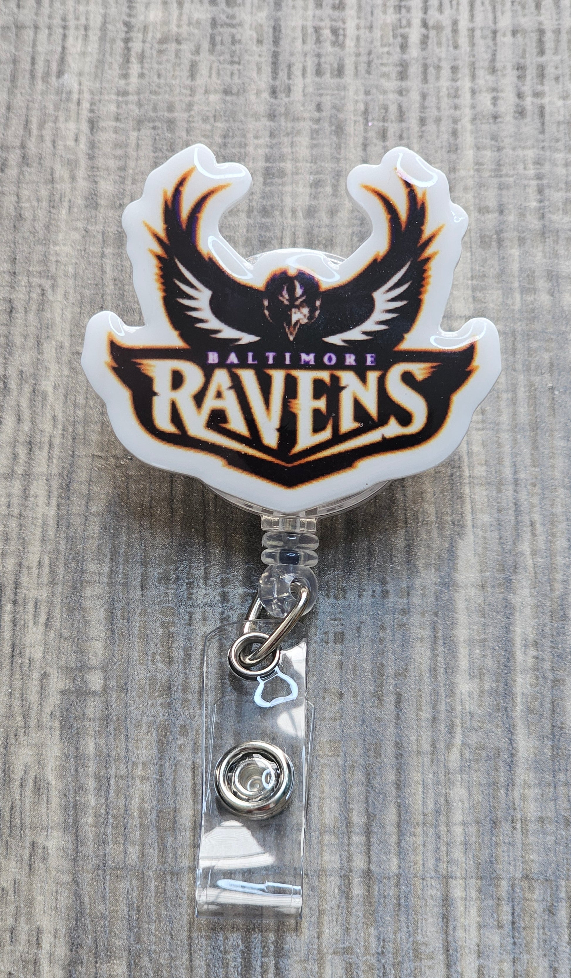 NFL Baltimore Ravens helmet with team logo and "Baltimore Ravens" text on a retractable badge reel.