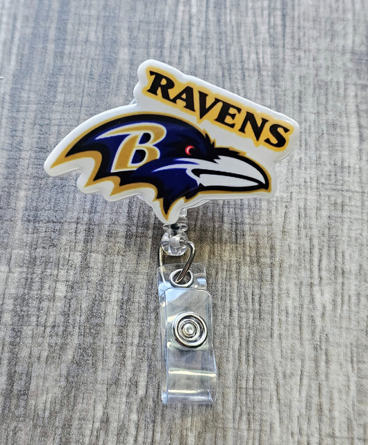 Ravens-inspired bird mascot badge reel with football beads, crafted in white acrylic.