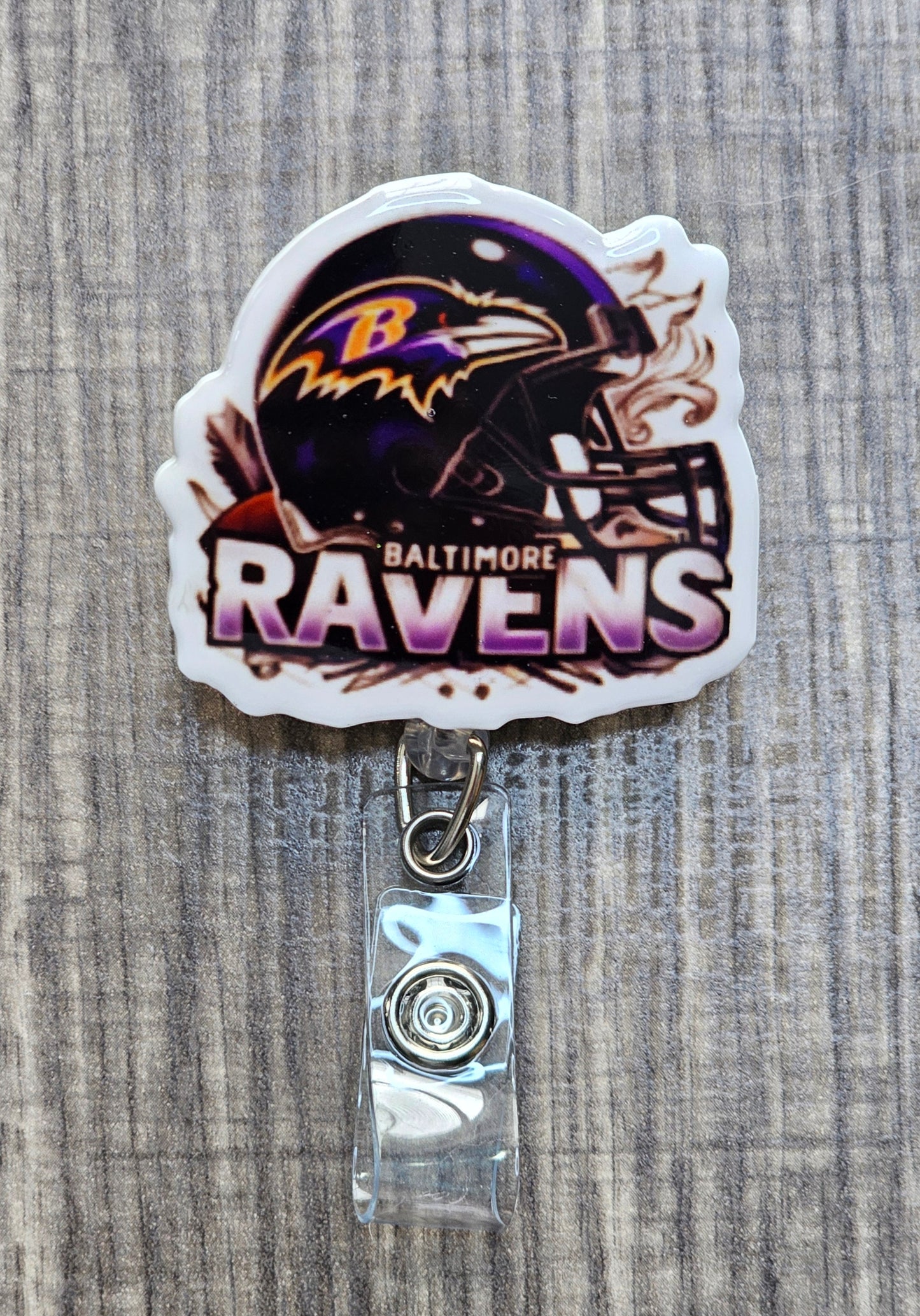 NFL Baltimore Ravens helmet with team logo and "Baltimore Ravens" text on a retractable badge reel.