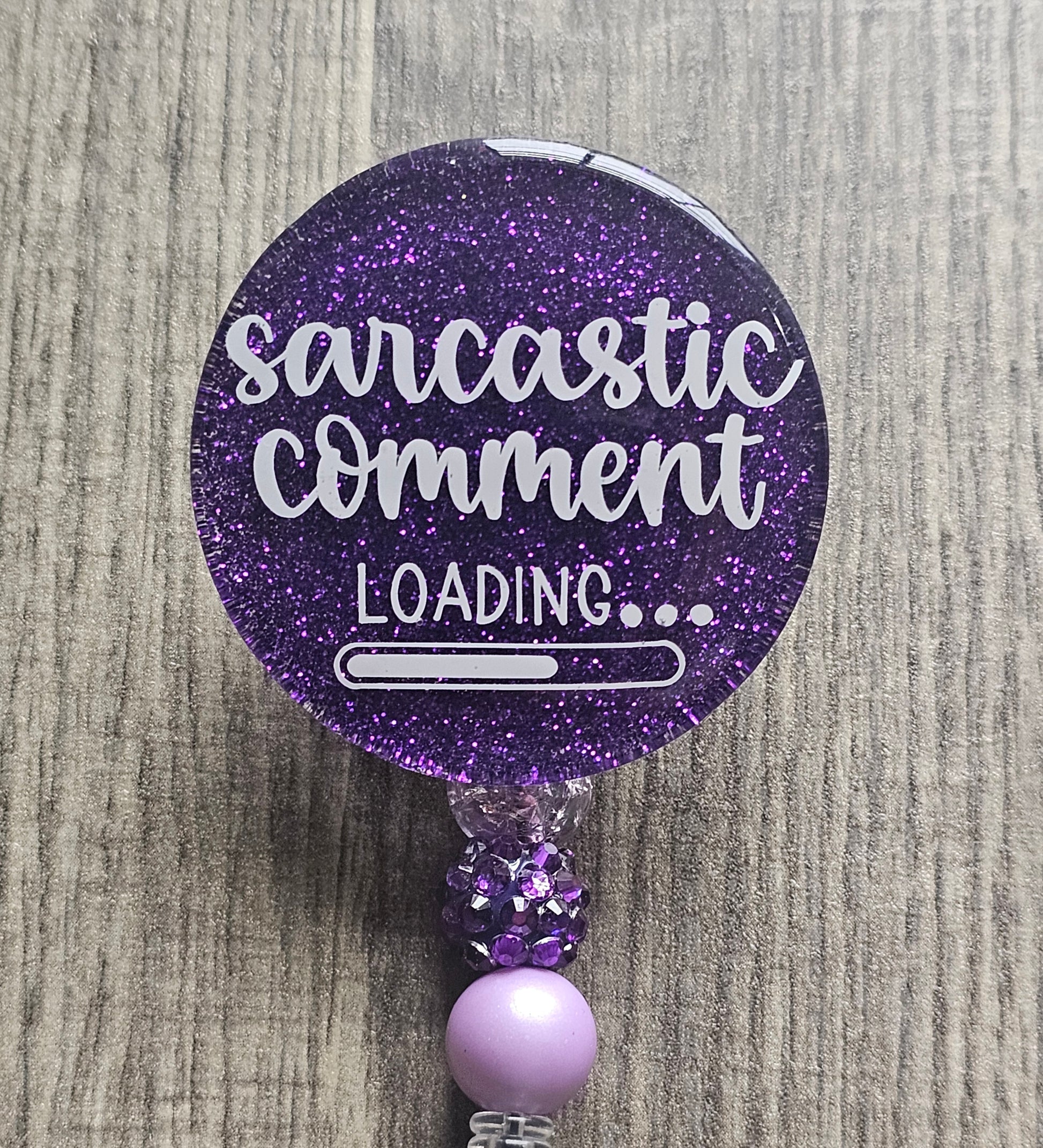 a badge reel stating Sarcastic comment loading with a loading bar incorporated within the design 