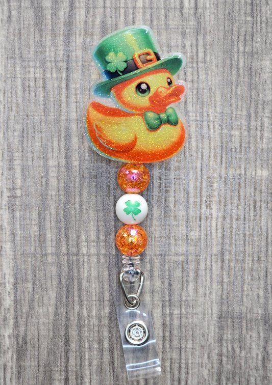 A badge reel featuring an adorable duck wearing a clover hat and bow tie in honor of St. Patrick’s Day.