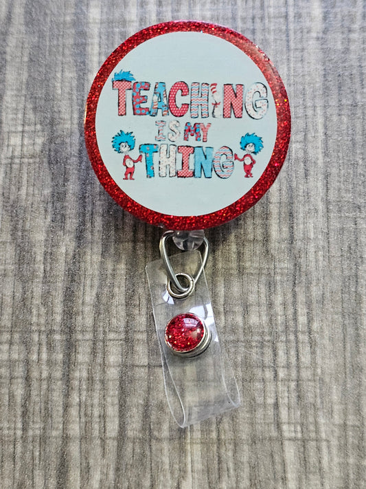 A badge reel with the statement Teaching Is my Thing with a red background 