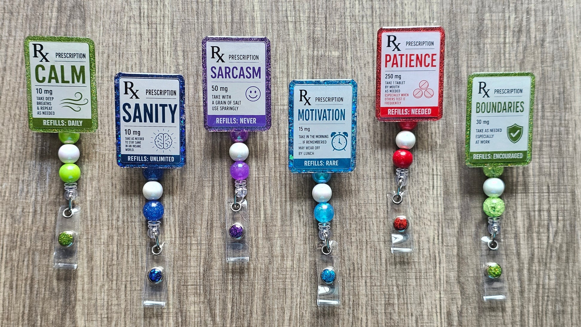 Faux medical prescription labels for Sanity, Motivation, Calm, and Patience on retractable work badge reels.