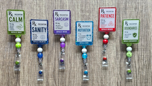 Faux medical prescription labels for Sanity, Motivation, Calm, and Patience on retractable work badge reels.