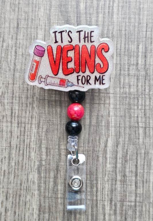 Medical badge reel with a blood vial and syringe illustration next to the phrase It's the veins for me.