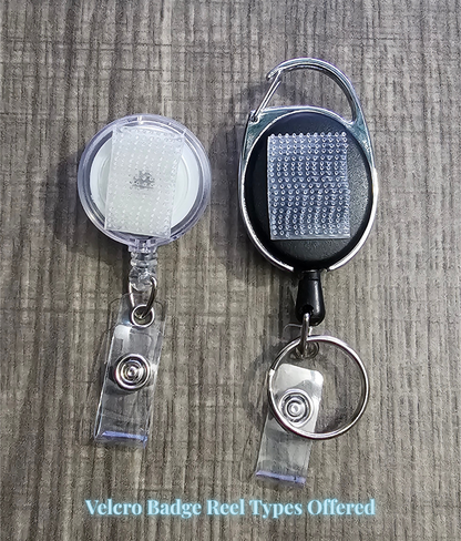 Two Velcro badge reels on a wooden surface with text indicating types offered.
